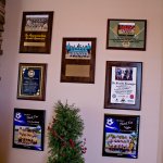 {PRACTICE_NAME} Award Plaques on Display  on office wall
