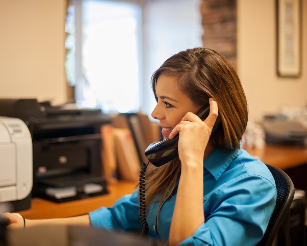 employee on phone at the front desk