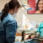 doctor in scrubs looking down towards patient