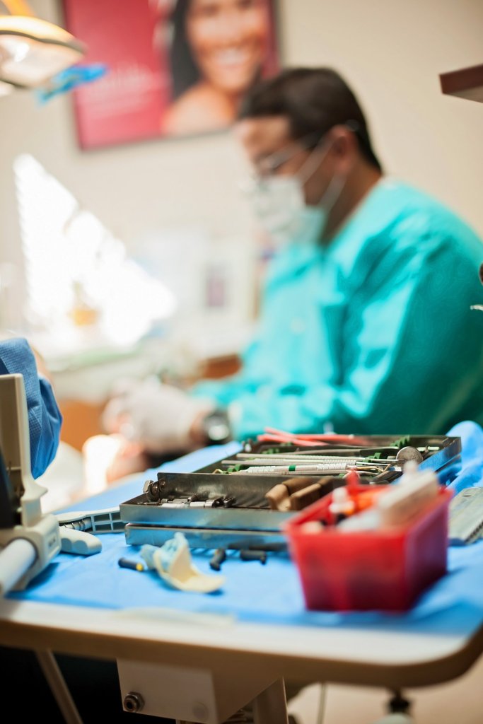 Dr. Bocanegra attending to patient with a tray of dental tools next to him