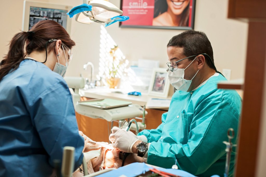 {PRACTICE_NAME}'s Dr. Bocanegra on scrubs attending to a patient