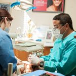 {PRACTICE_NAME}'s Dr. Bocanegra on scrubs attending to a patient