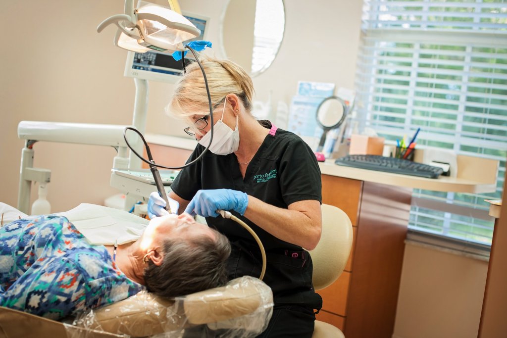 {PRACTICE_NAME} Dental Hygienist attending to patient