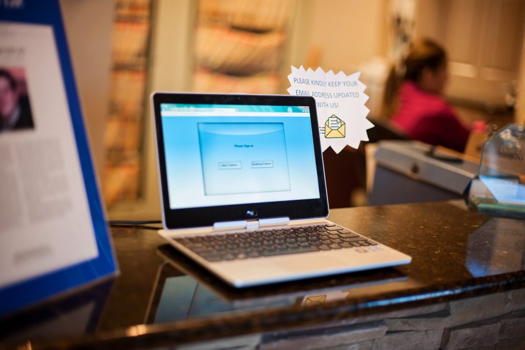 Laptop on counter of front desk at {PRACTICE_NAME}